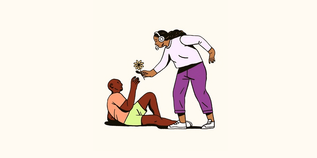 A customer support agent hands a customer a flower.