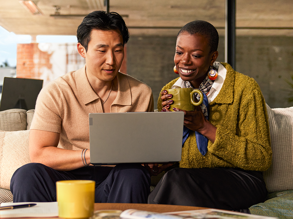 Two coworkers sitting together at a laptop
